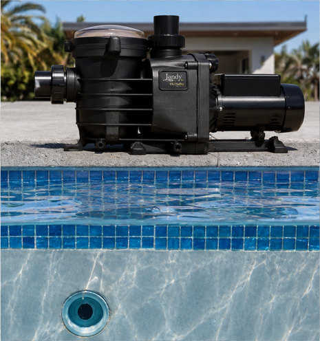 Pool pump installed beside a swimming pool by AquaPrime